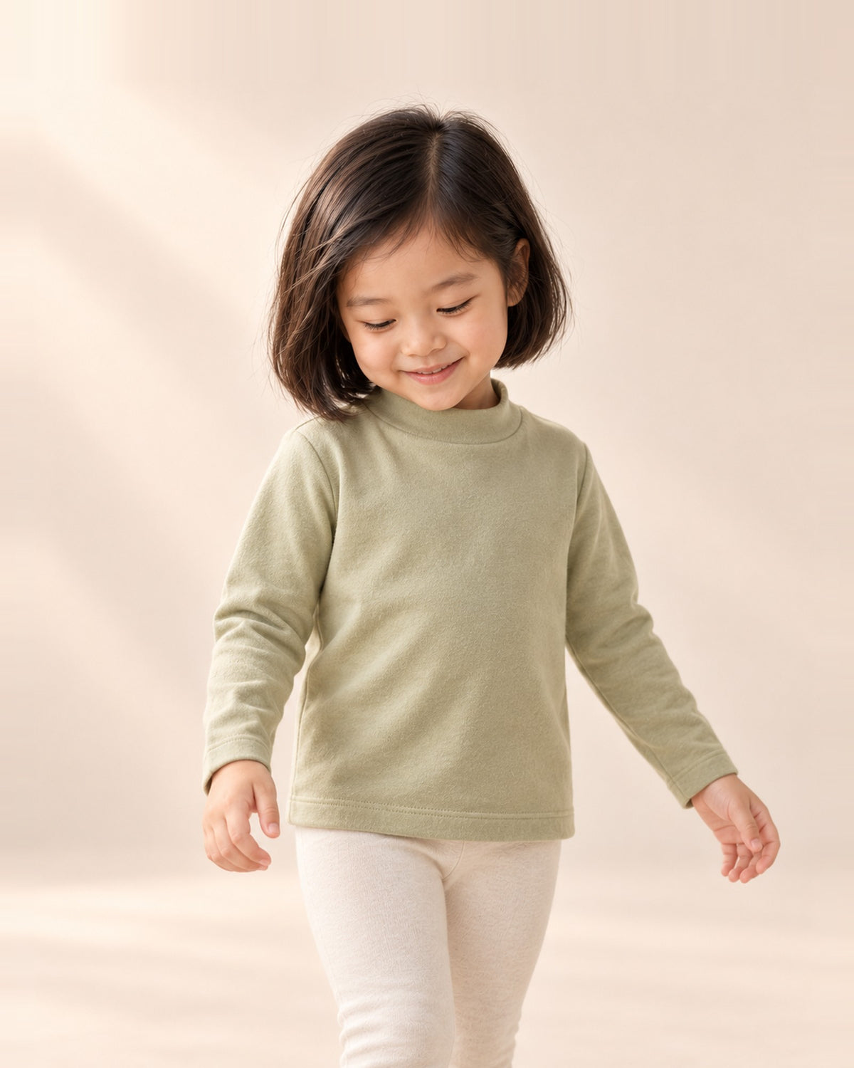 Close-up of the sage mock-neck long-sleeve top – Sage