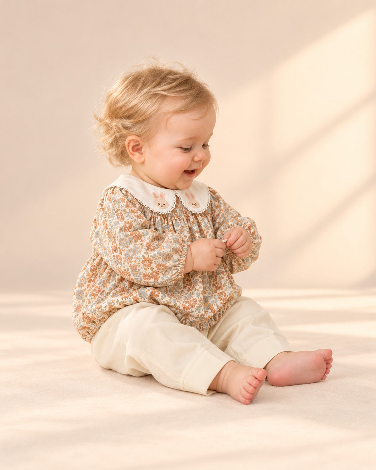 Side view of the cream wide-leg pants with the floral romper – Cream