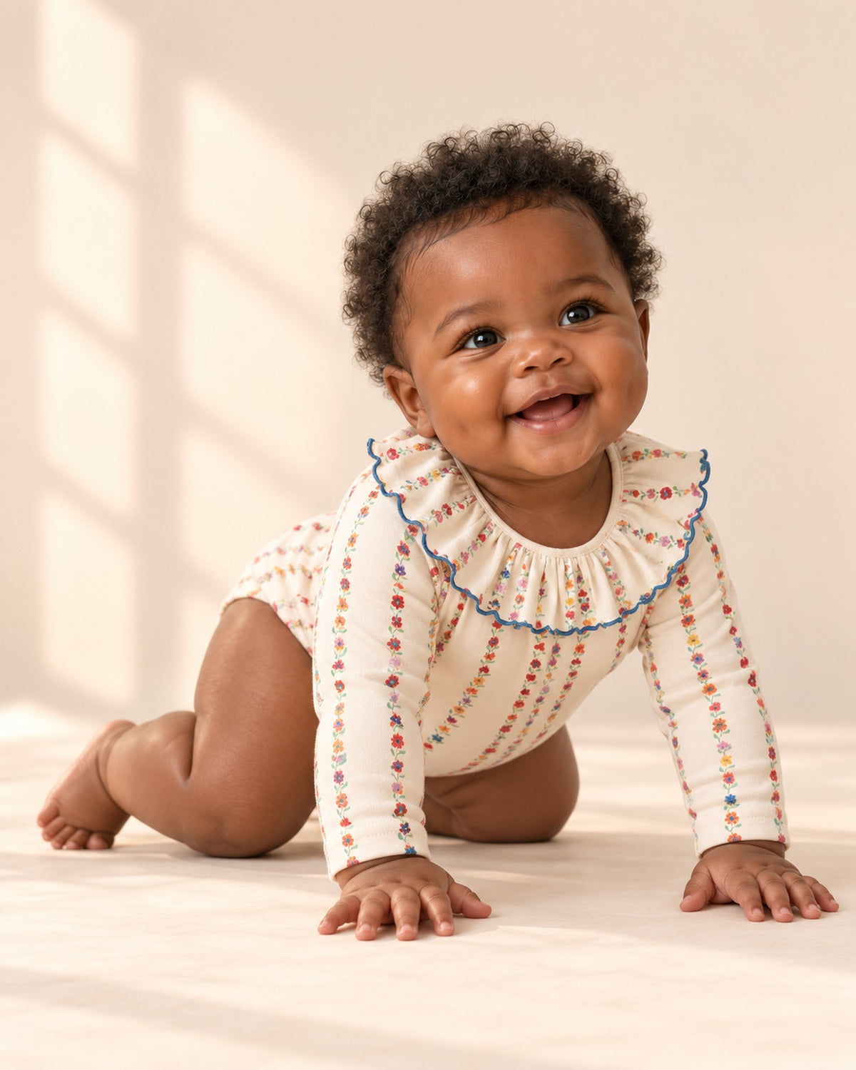 Baby in the ruffle collar bodysuit and open cream cardigan, shown relaxed – Floral Stripe
