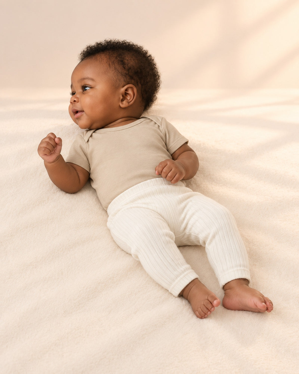 Side view of the oatmeal bodysuit with the cream leggings – Oatmeal