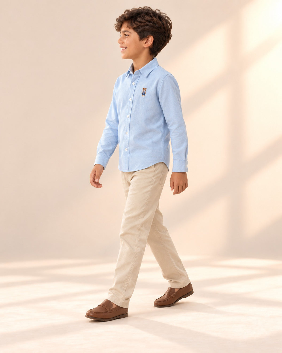 Side view of the oxford shirt under a camel rib sweater vest – Light Blue