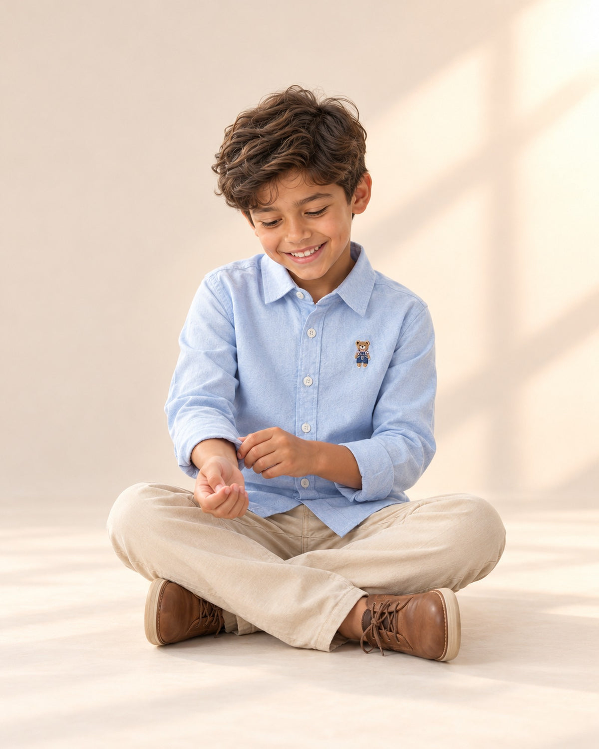 Boy in the light blue oxford shirt and camel sweater vest, standing relaxed – Light Blue