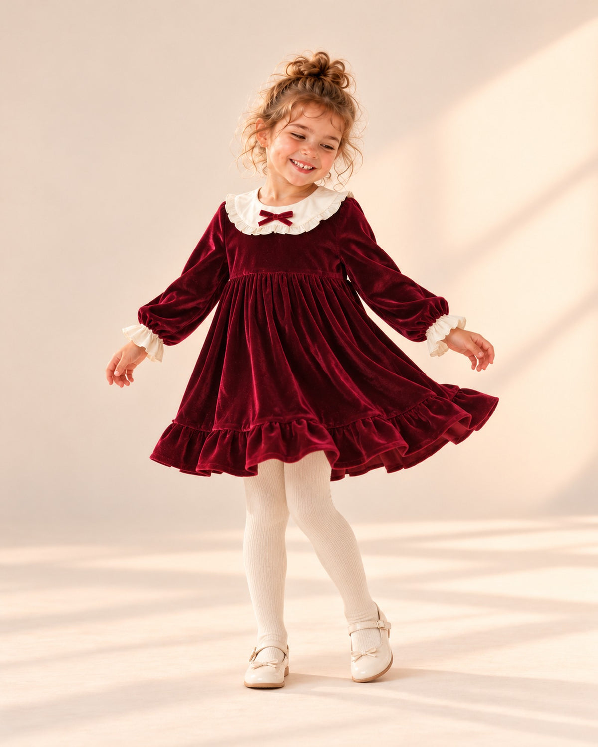 Girl in a natural pose wearing the burgundy velvet dress and cream tights – Burgundy