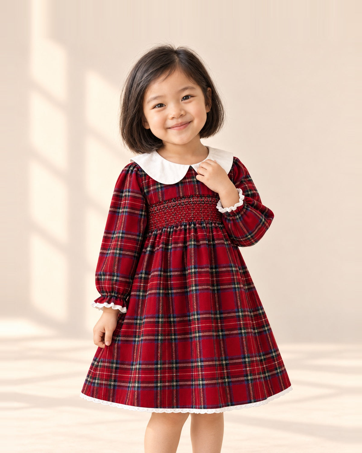 Girl in the Rosalie red tartan smocked dress with a white collar, shown from head to hem – Red Tartan