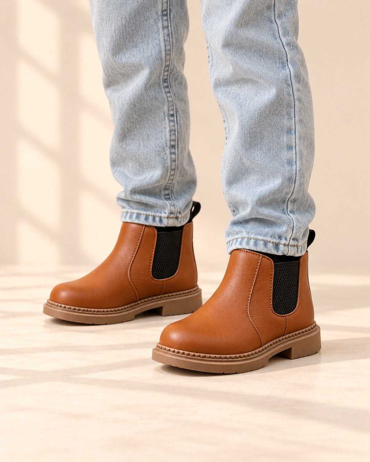 Close-up of a child's feet in cognac Chelsea boots with grey heather wool-blend socks – Cognac