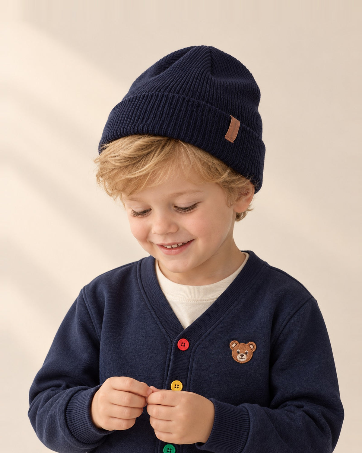 Close-up of a boy's head and shoulders in a navy cuffed knit beanie – Navy