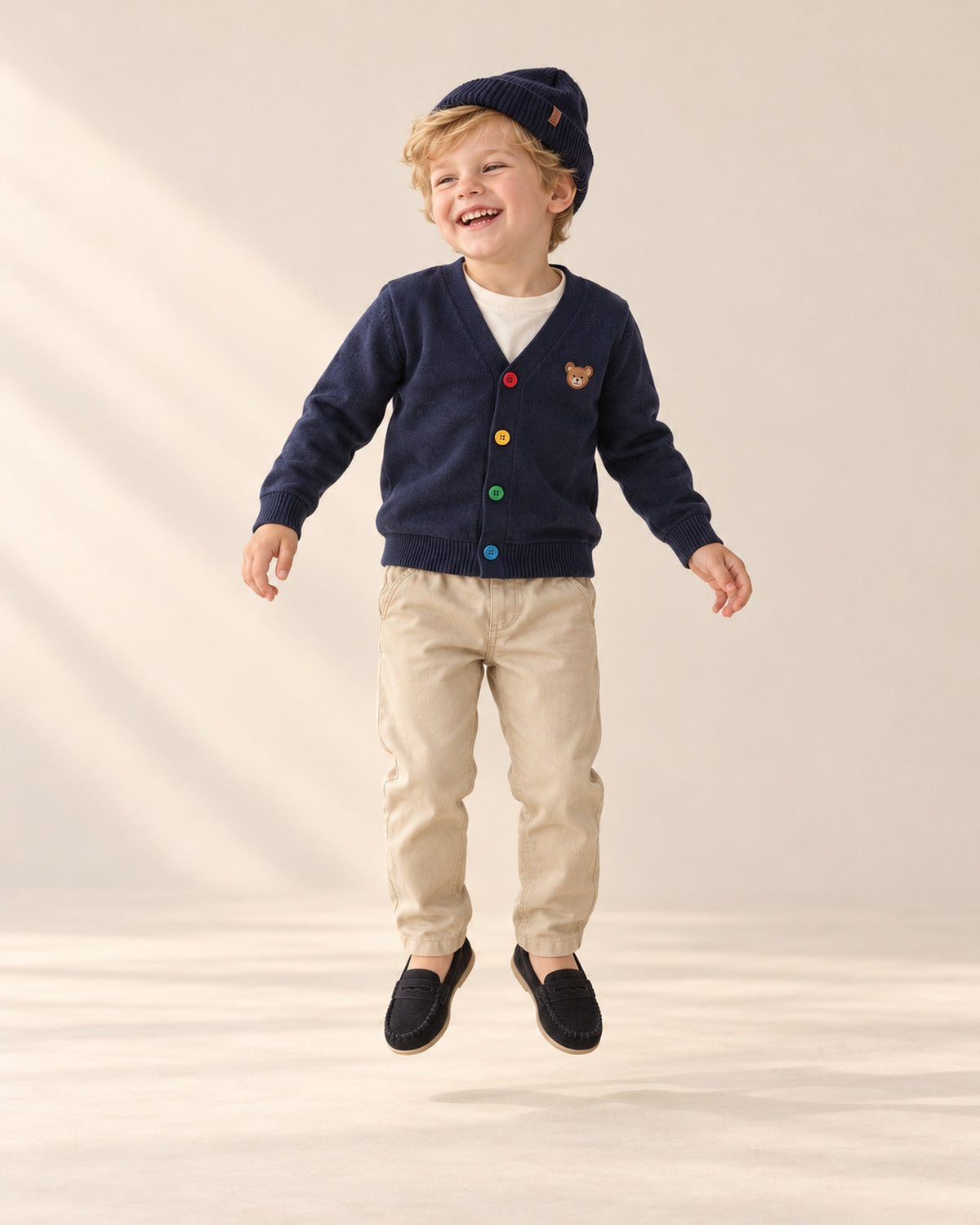 Boy laughing in his navy beanie and bear cardigan – Navy