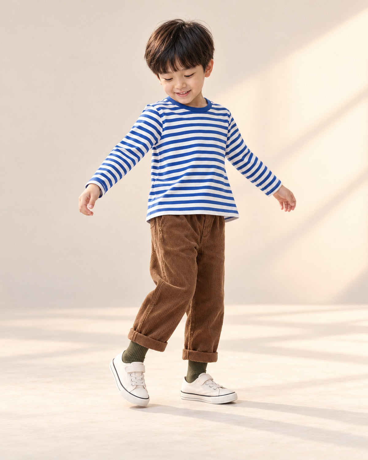 Boy sitting on a step in his Breton tee and corduroy pants, crew socks showing – Dark Mix