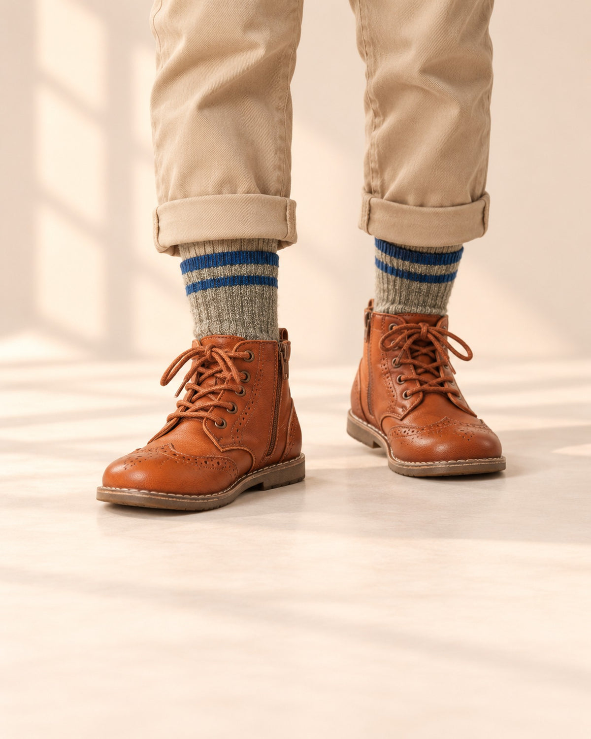 Close-up of a boy's legs from knee to floor in grey heather wool-blend socks and cognac brogue boots – Grey Heather