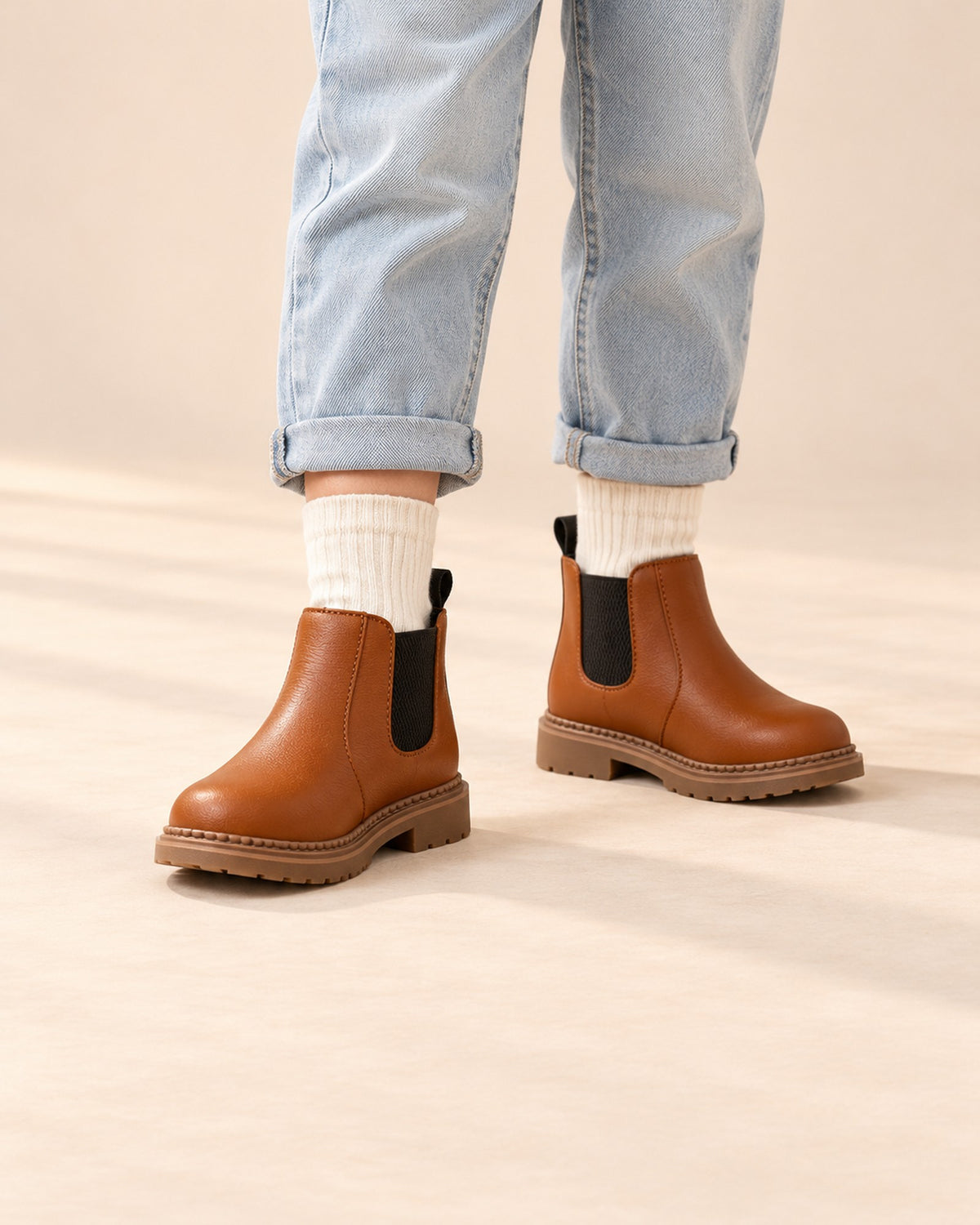Close-up of a boy's legs from knee to floor in cream crew socks and cognac Chelsea boots – Cream