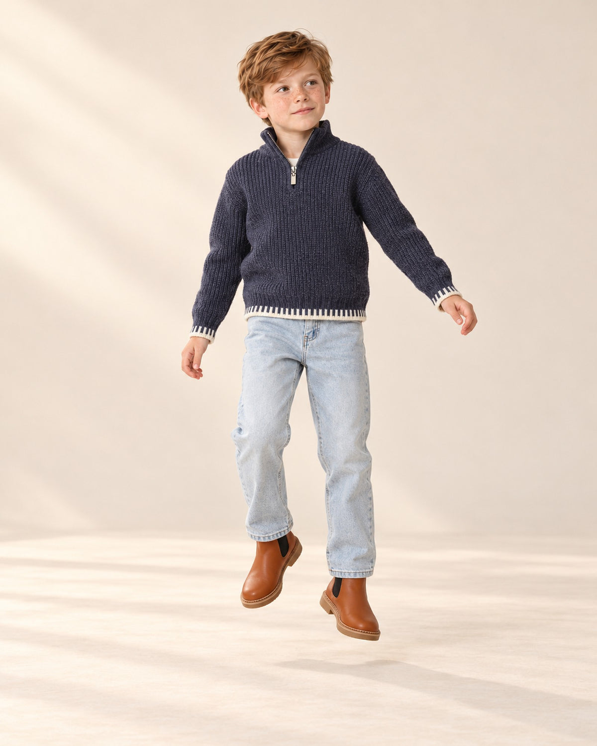 Boy in the navy Harrison half-zip sweater and jeans, relaxed pose in the studio, head to toe – Navy