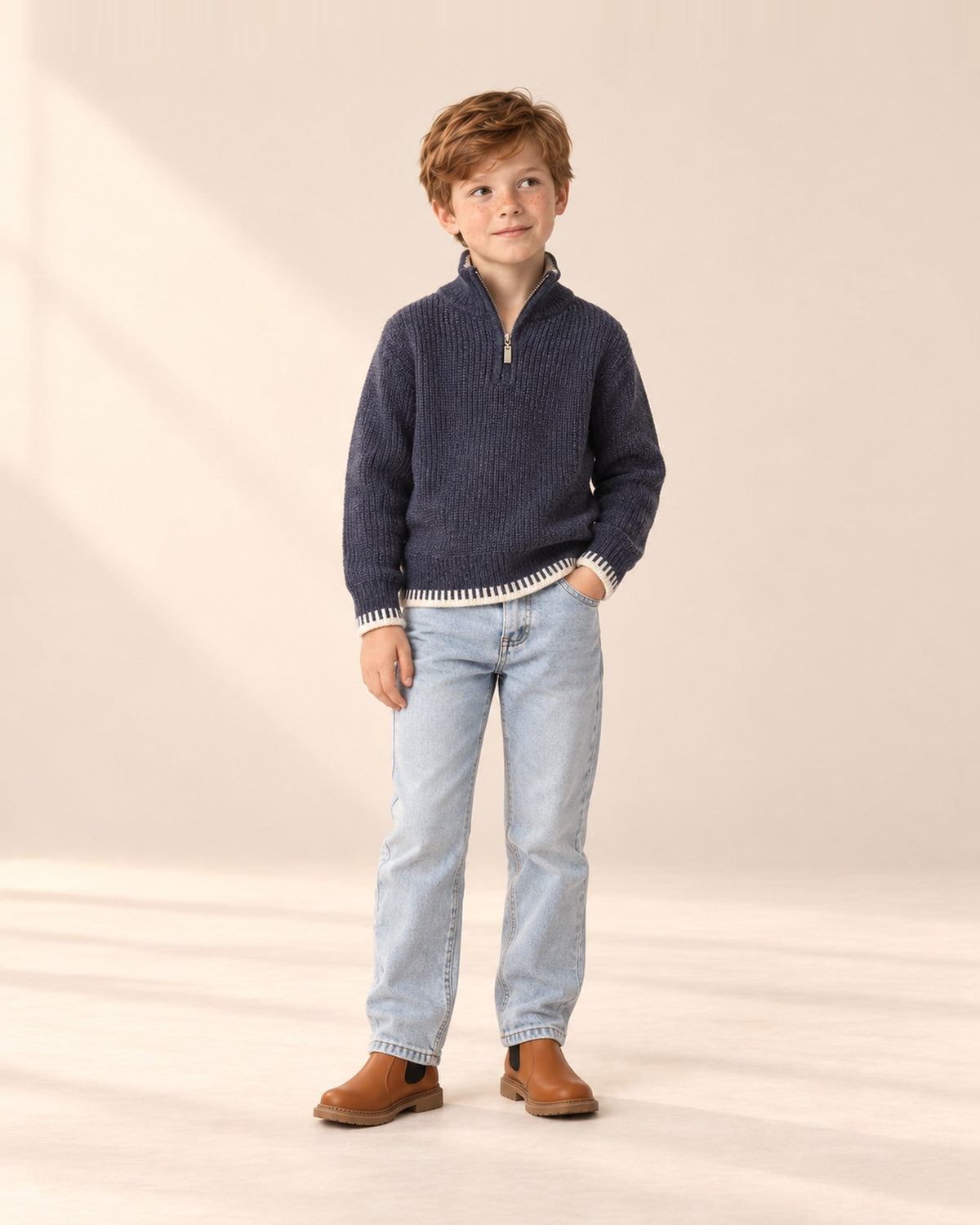 Boy in the navy Harrison half-zip sweater and jeans, relaxed pose in the studio, head to toe – Navy