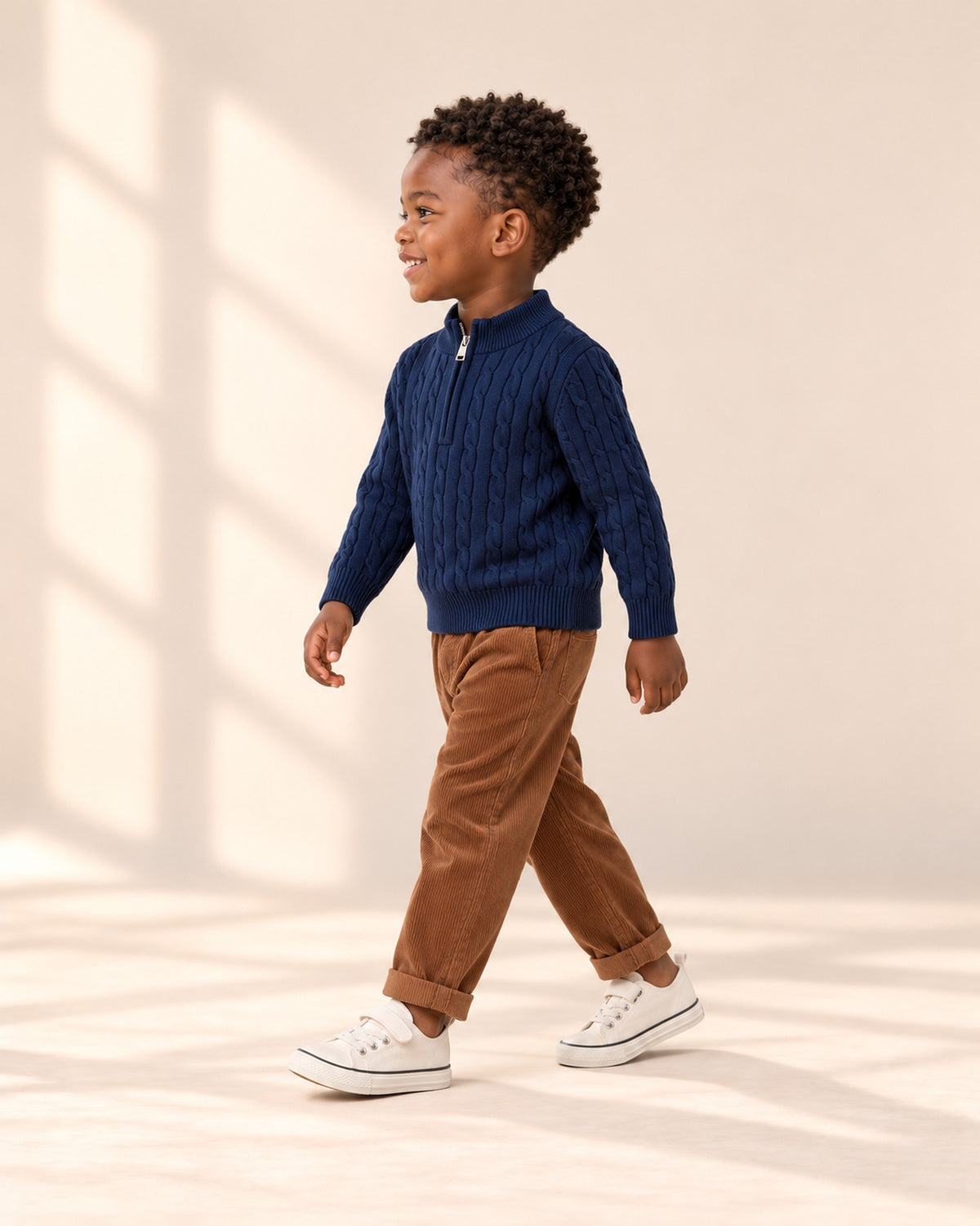 Side view of the navy cable sweater with corduroy pants and canvas sneakers – Navy