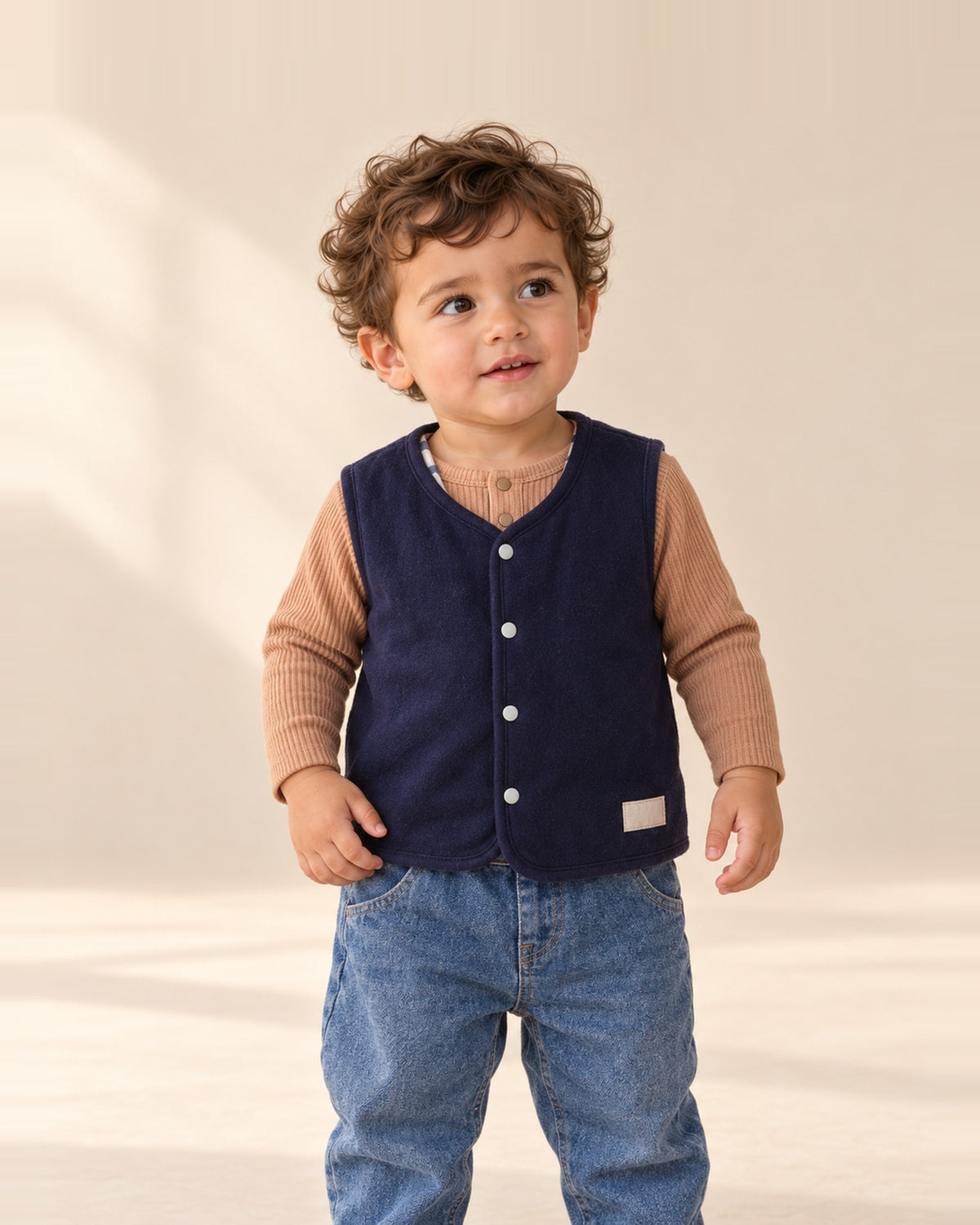 Close-up of the navy reversible vest with button front and a glimpse of the blue check lining – Navy