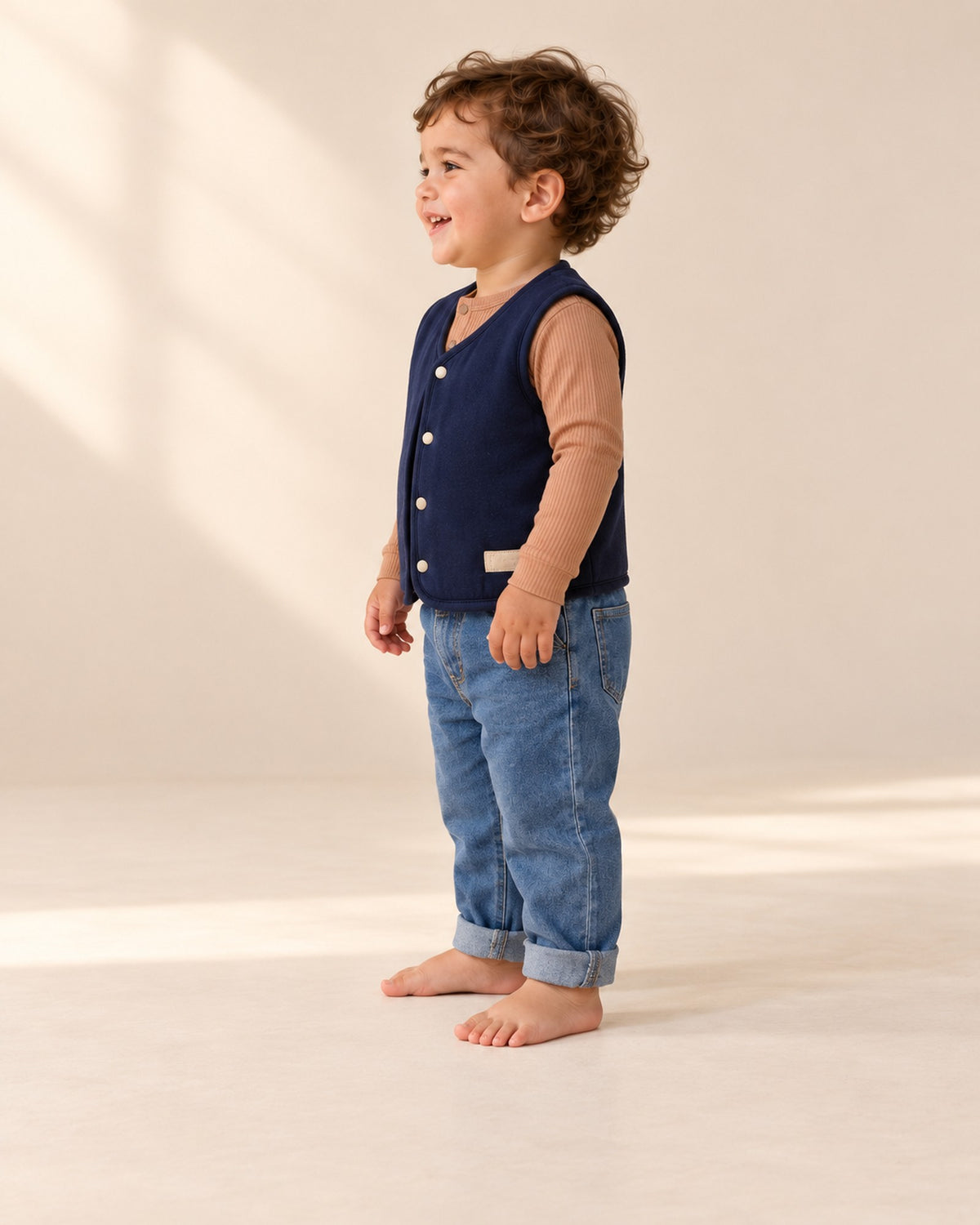 Side view of the navy vest with the caramel henley bodysuit and baby jeans – Navy